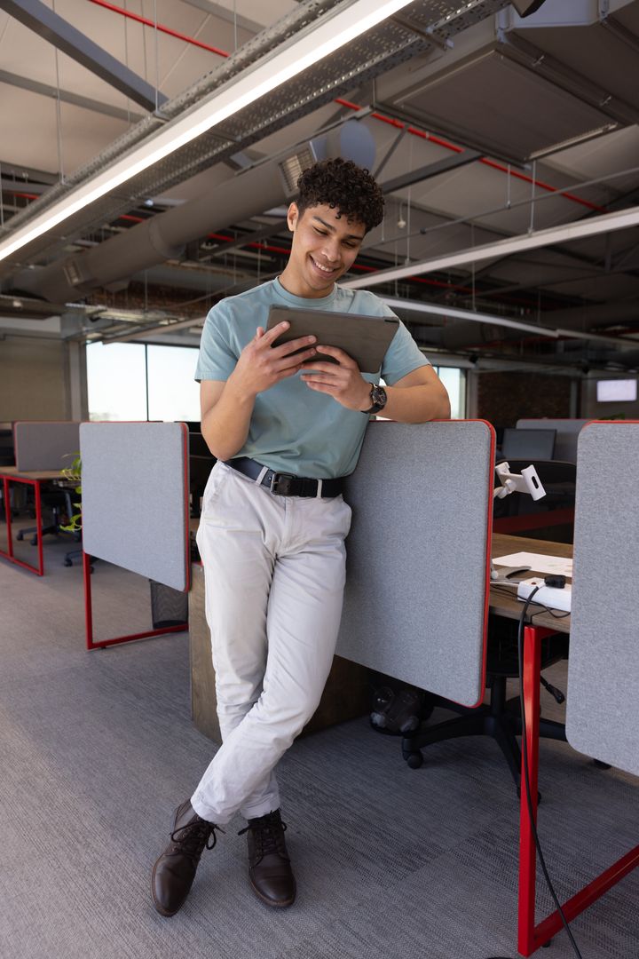 Smiling Professional Using Tablet in Modern Office Setting