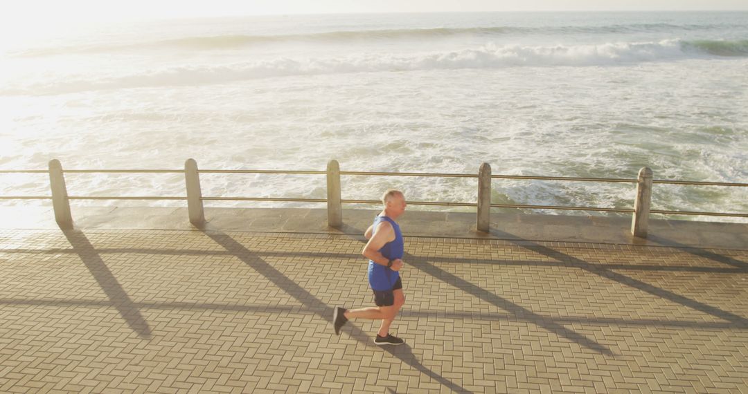 Man Running on Beachside Path at Sunrise - Free Images, Stock Photos and Pictures on Pikwizard.com