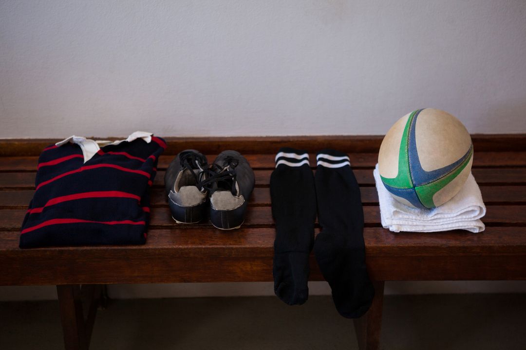 Rugby Gear on Wooden Bench in Locker Room - Free Images, Stock Photos and Pictures on Pikwizard.com