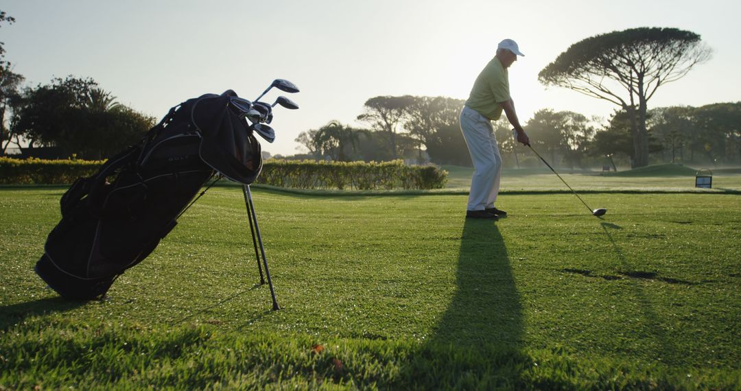 Golfer Practicing Swing on Scenic Green with Golf Bag