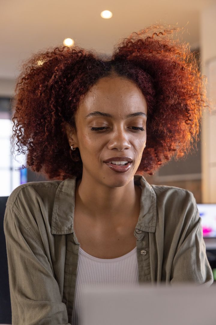 African American Woman Focusing on Laptop in Modern Home Office