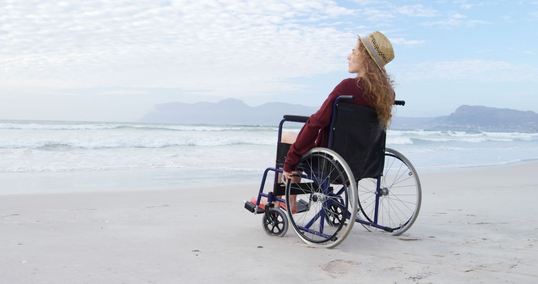 Woman in wheelchair on beach enjoying scenic ocean view - Free Images, Stock Photos and Pictures on Pikwizard.com