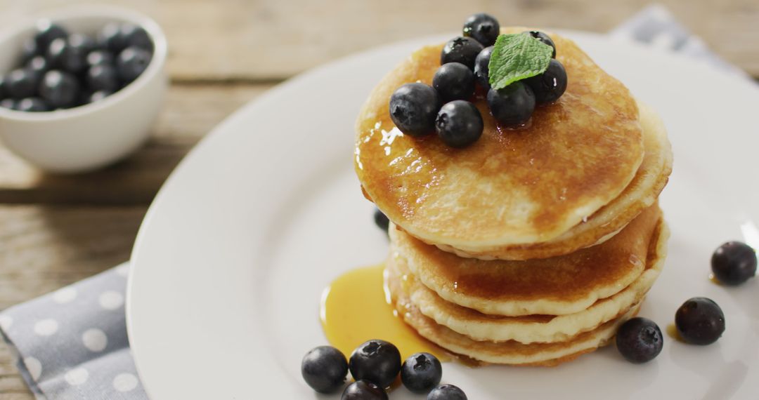 Stack of Fluffy Pancakes with Blueberries and Maple Syrup