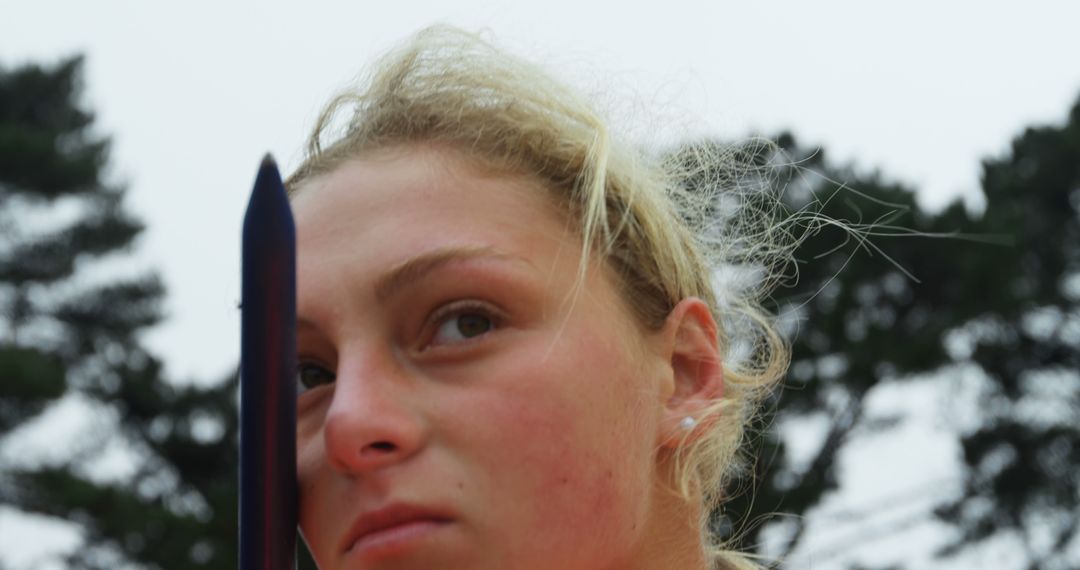 Caucasian Female Athlete Focuses on Javelin Throw