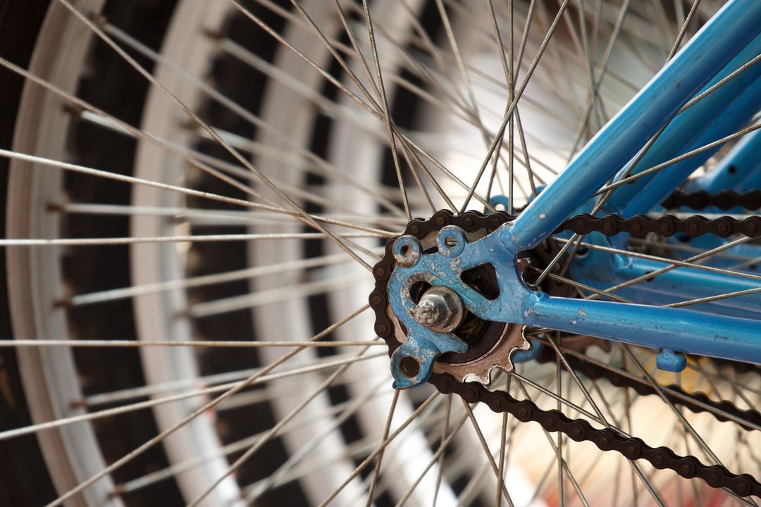 Close-Up of Bicycle Wheel Highlighting Metal Spokes and Chain
