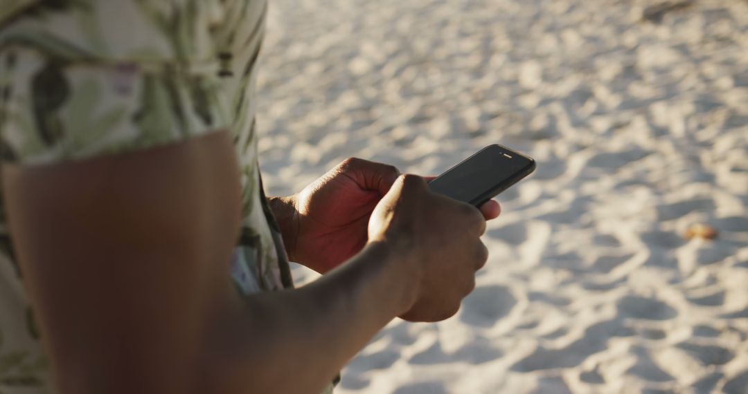 Person Using Smartphone on Sandy Beach - Free Images, Stock Photos and Pictures on Pikwizard.com