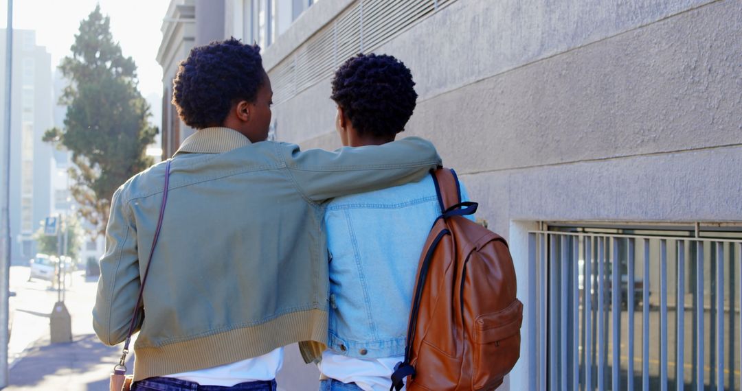 Twin Sisters Strolling in Urban Area Engaged in Conversation