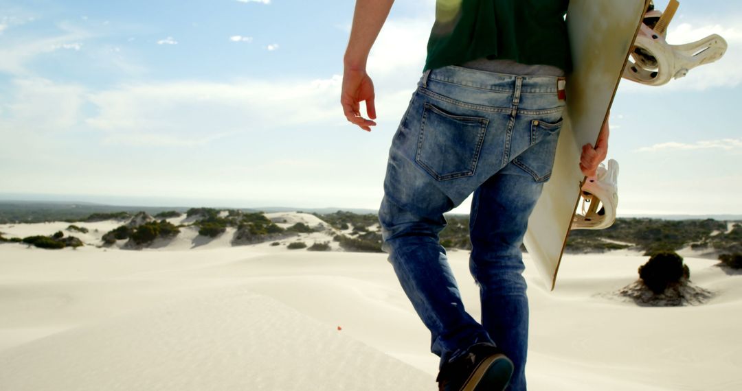 Man Holding Sandboard Walking On Desert Dunes - Free Images, Stock Photos and Pictures on Pikwizard.com