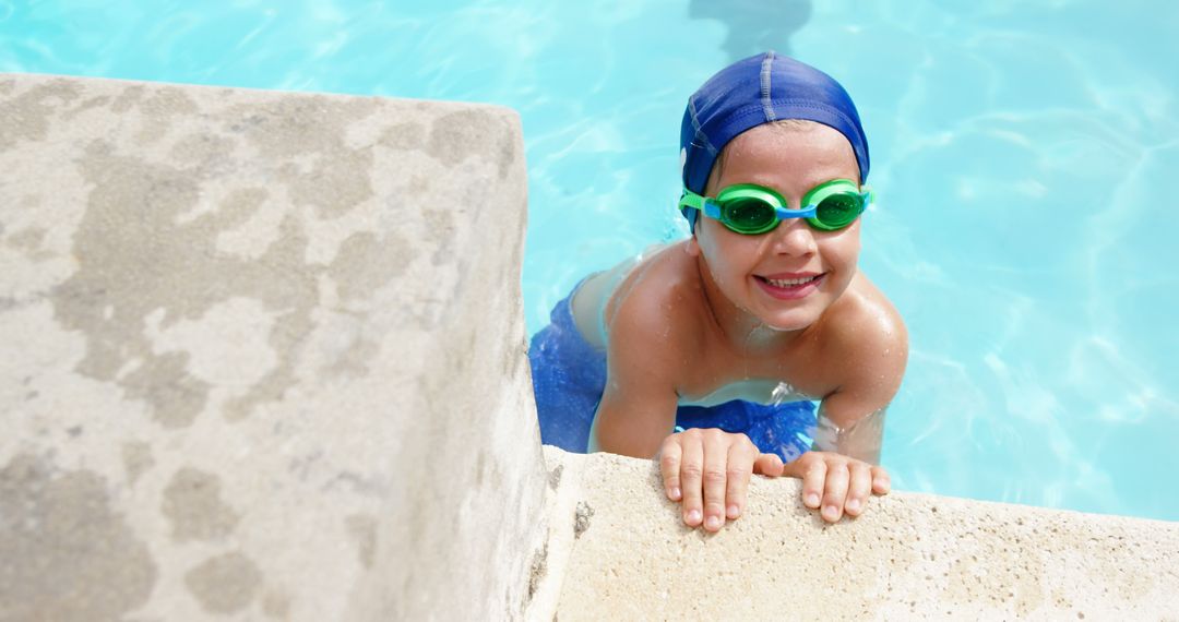 Smiling Young Boy Swimming in Pool with Goggles and Swim Cap - Free Images, Stock Photos and Pictures on Pikwizard.com