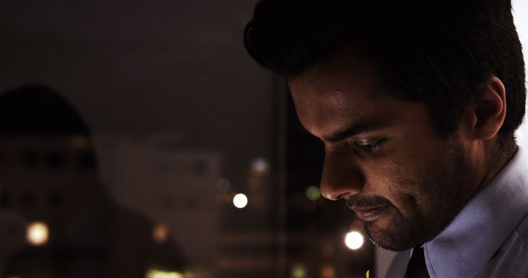 Focused Business Professional Analyzing Data on Tablet at Night