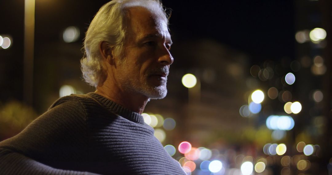 Older Man Contemplating City Lights at Night - Free Images, Stock Photos and Pictures on Pikwizard.com