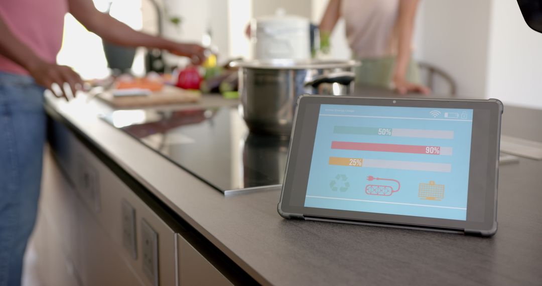 Tablet Displaying Energy Usage in Modern Kitchen Environment