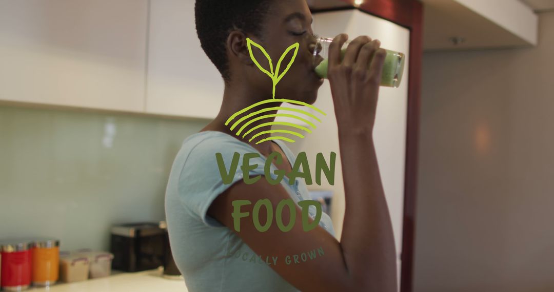 Image of vegan food locally grown text and plant, african american woman drinking juice at home - Free Images, Stock Photos and Pictures on Pikwizard.com