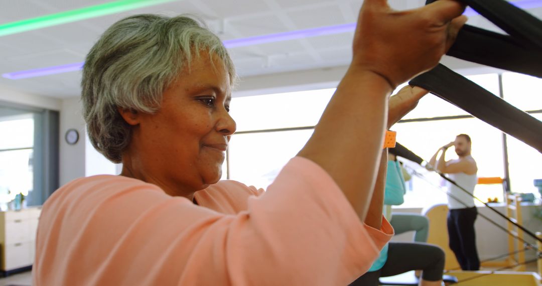 Senior Woman Exercising on Fitness Equipment in Gym - Free Images, Stock Photos and Pictures on Pikwizard.com