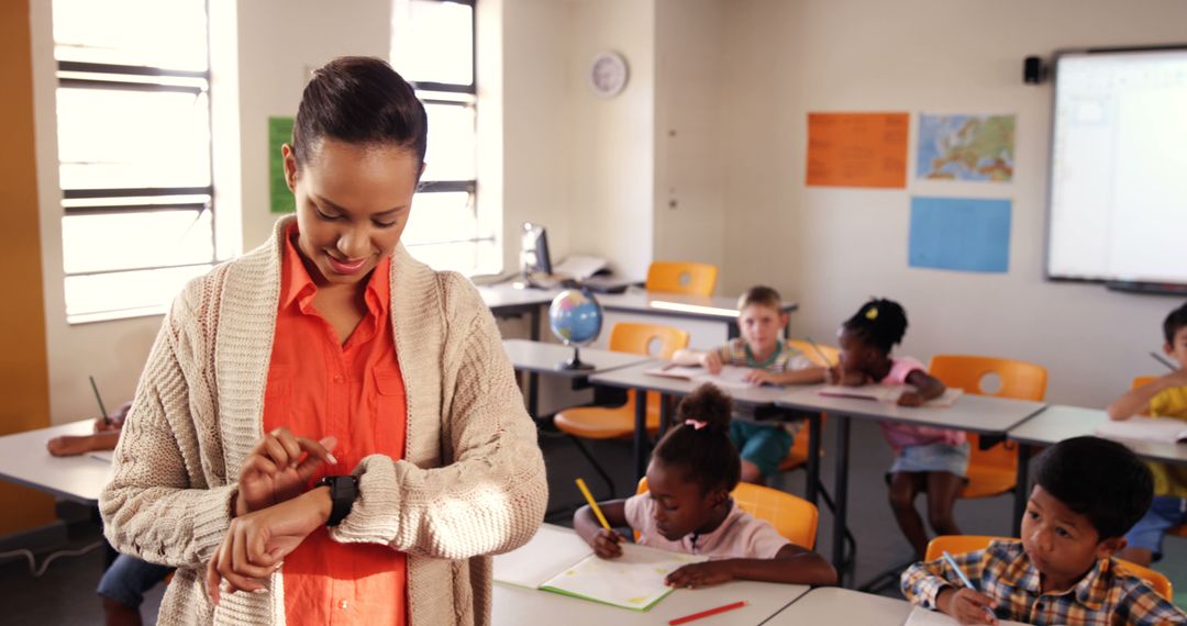 Teacher Checking Smart Watch in Active Classroom Environment
