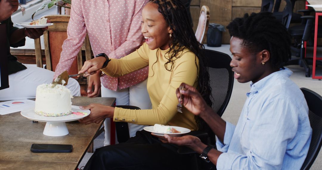Colleagues Celebrating with Cake in Modern Office Environment