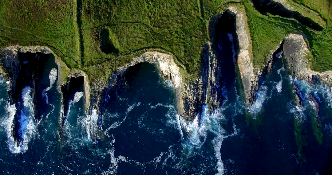 Aerial View of Transparent Ocean Water Crashing Against Daily Lush Green Cliffs - Download Free Stock Images Pikwizard.com