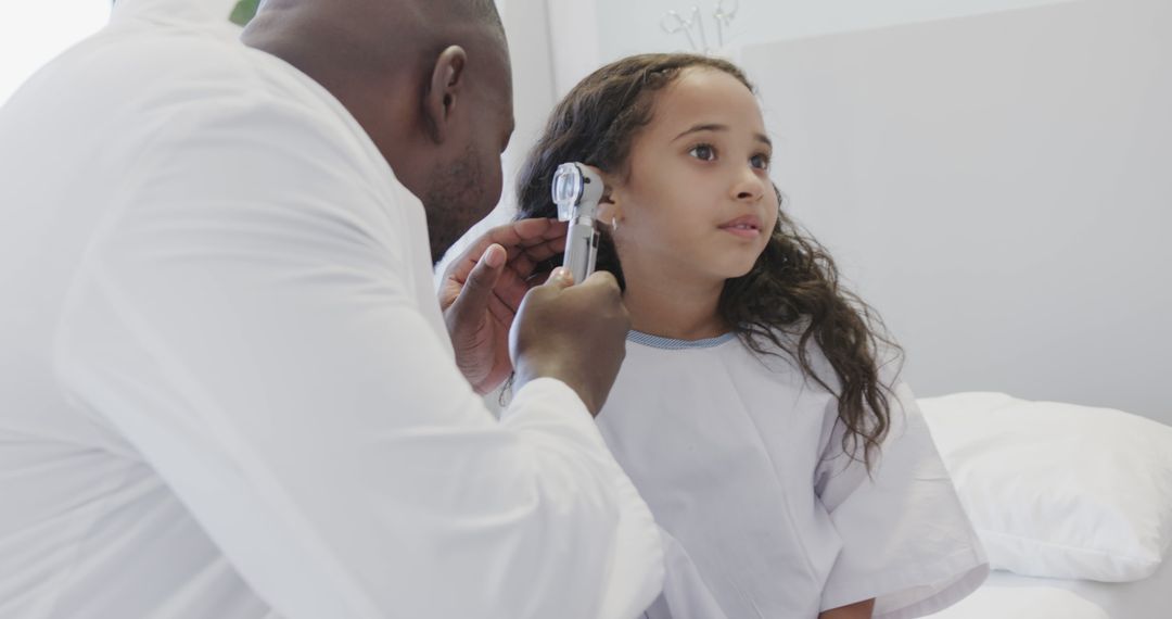 Doctor Examining Child's Ear During Checkup - Free Images, Stock Photos and Pictures on Pikwizard.com