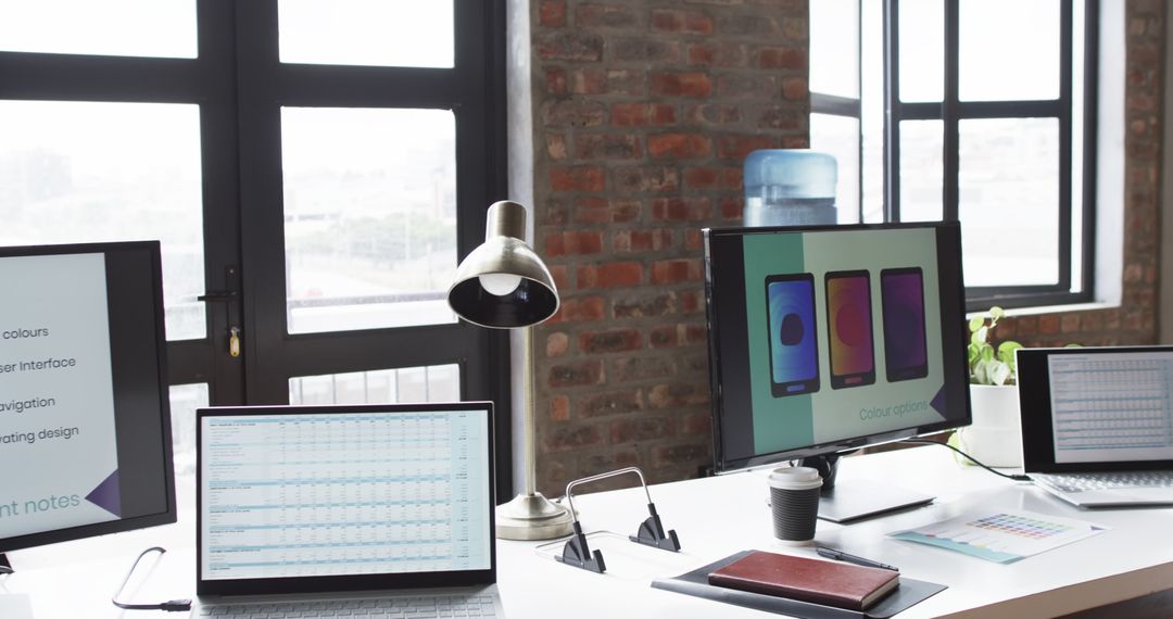 Modern Workspace With Multiple Screens and Office Supplies