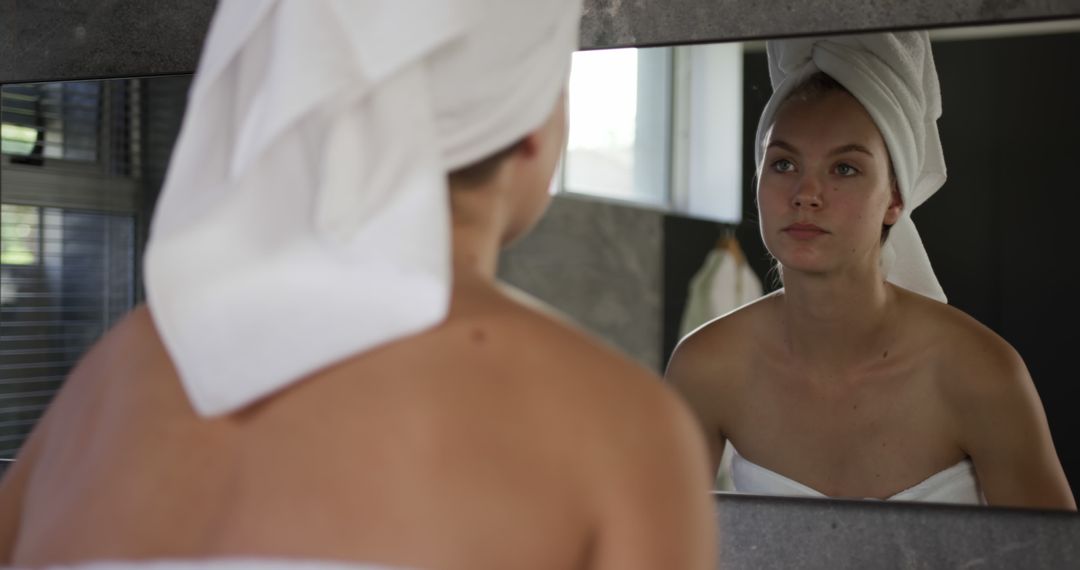 Woman Reflecting in Bathroom Mirror with Towel on Head - Free Images, Stock Photos and Pictures on Pikwizard.com