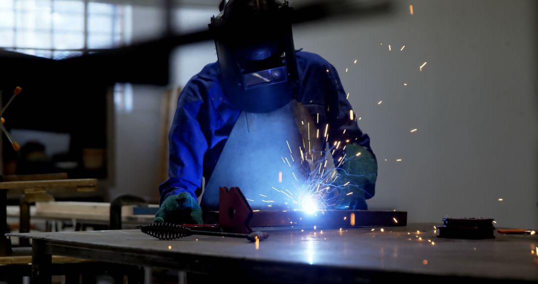 Industrial Welder Wearing Protective Gear Welding Metal Pieces in Workshop - Free Images, Stock Photos and Pictures on Pikwizard.com