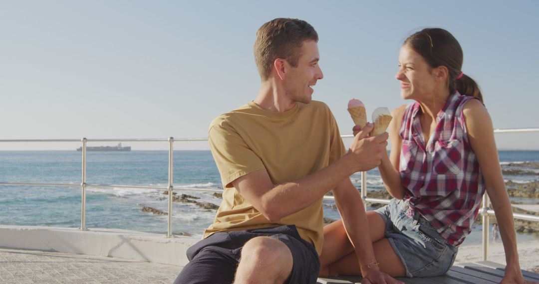 Young Couple Enjoying Ice Cream by Seaside on Summer Day - Free Images, Stock Photos and Pictures on Pikwizard.com