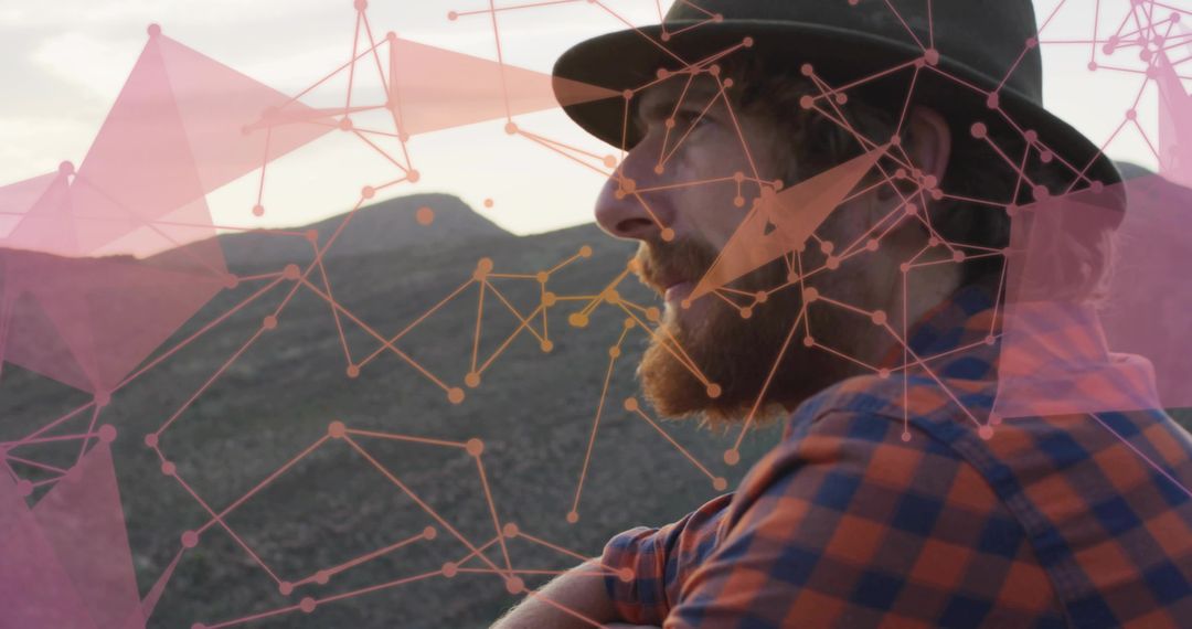 Man in Fedora Staring Across Rugged Terrain with Digital Overlay