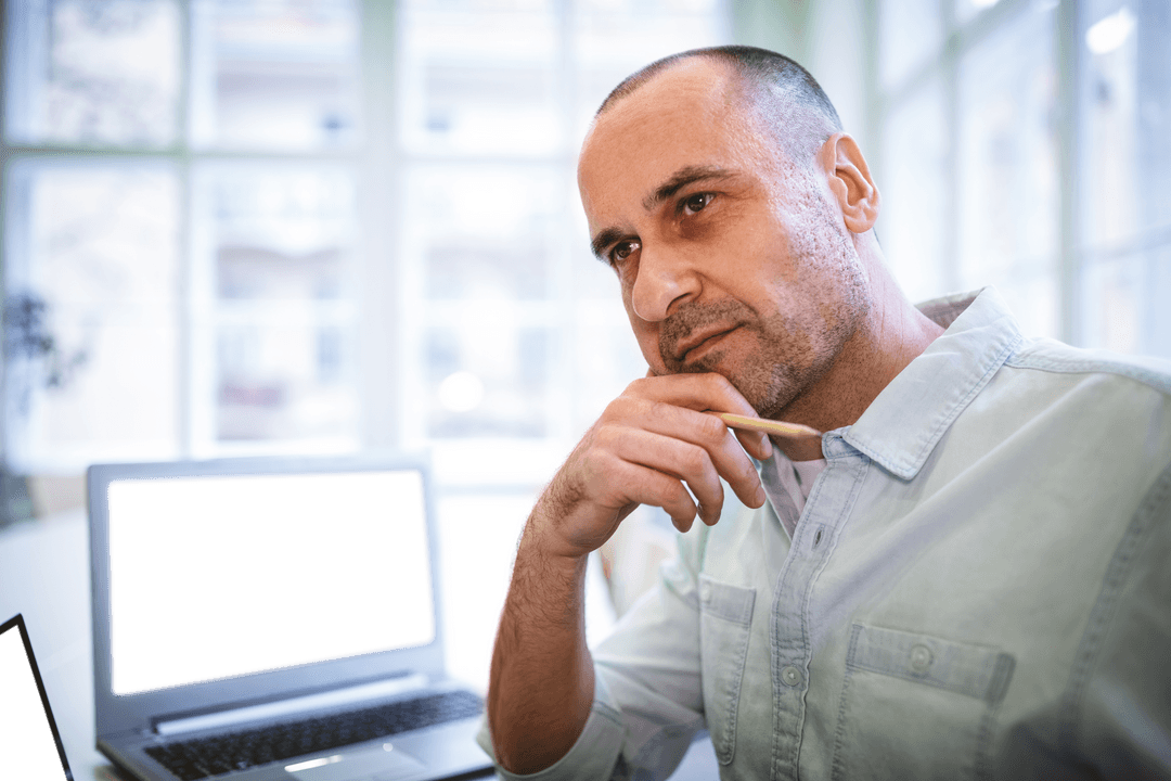 Transparent Thoughtful Man Working on Laptop in Bright Office