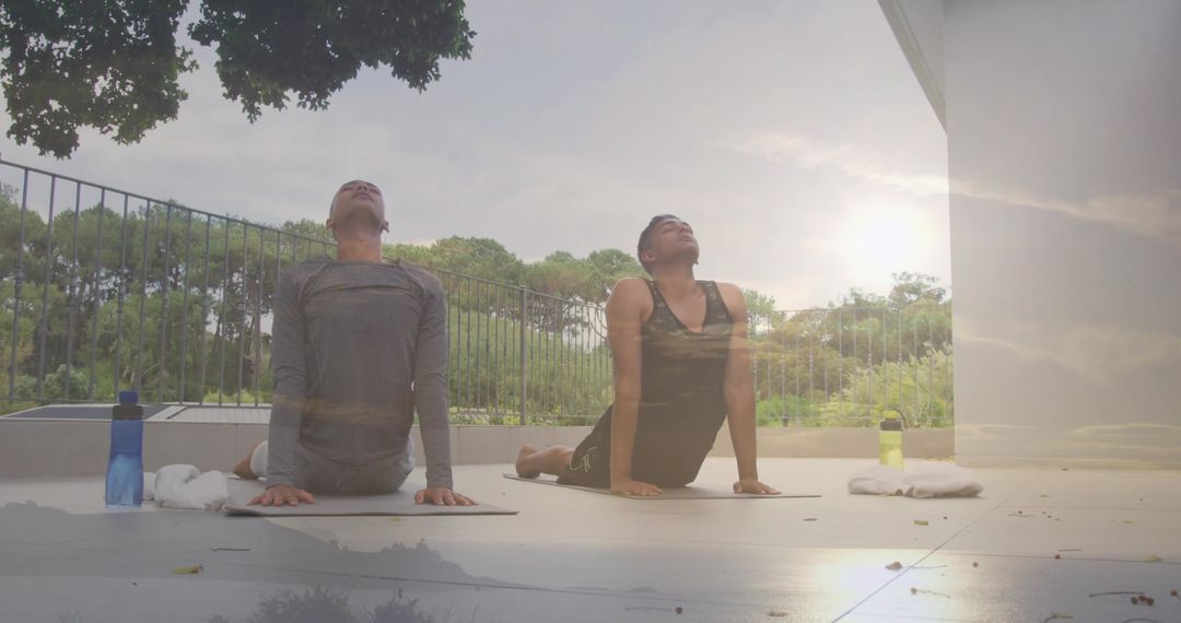 Men Practicing Yoga on Balcony with Scenic Natural Backdrop