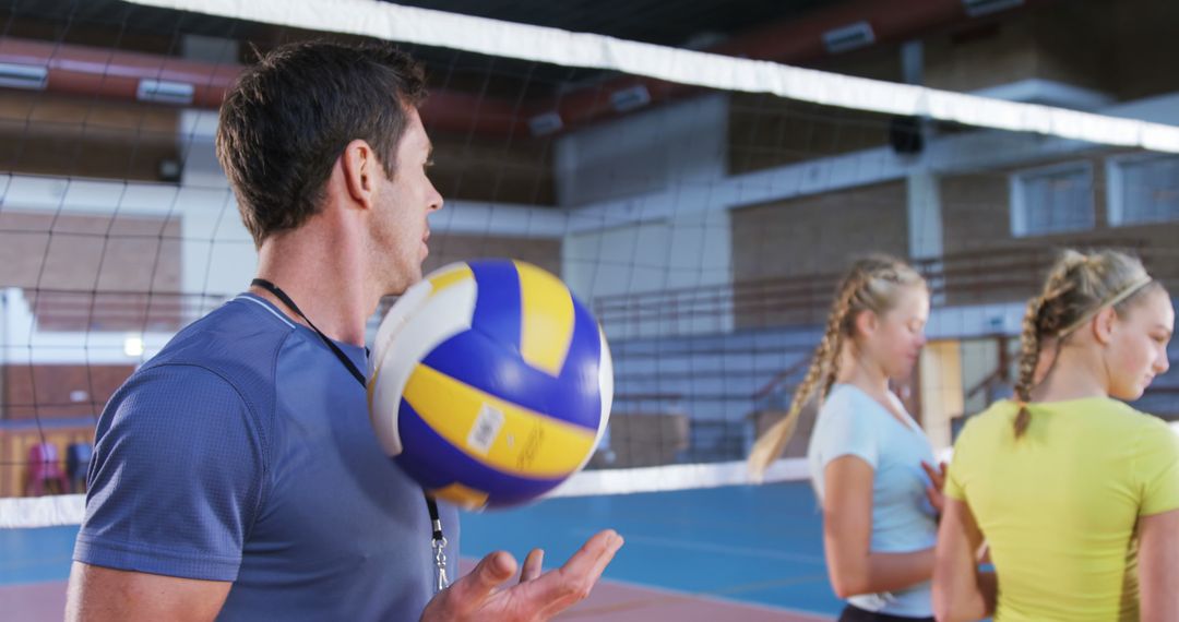 Volleyball Coach Training Female Students in Indoor Gym - Free Images, Stock Photos and Pictures on Pikwizard.com