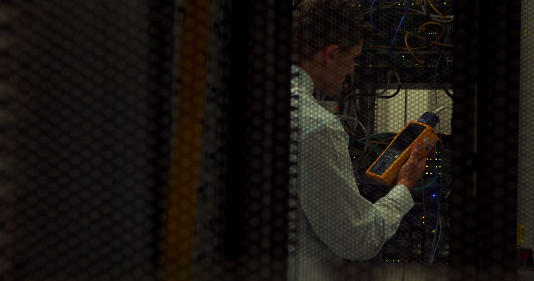 IT Technician Working on Server Rack with Cable Tester - Free Images, Stock Photos and Pictures on Pikwizard.com