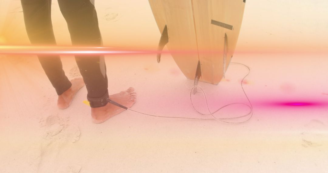 Surfer with Board on Sand Enjoys Stunning Light Effects