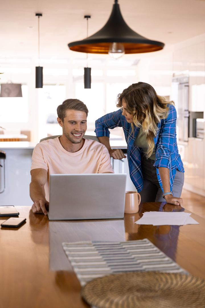 Couple Collaborating on Home Project at Kitchen Table