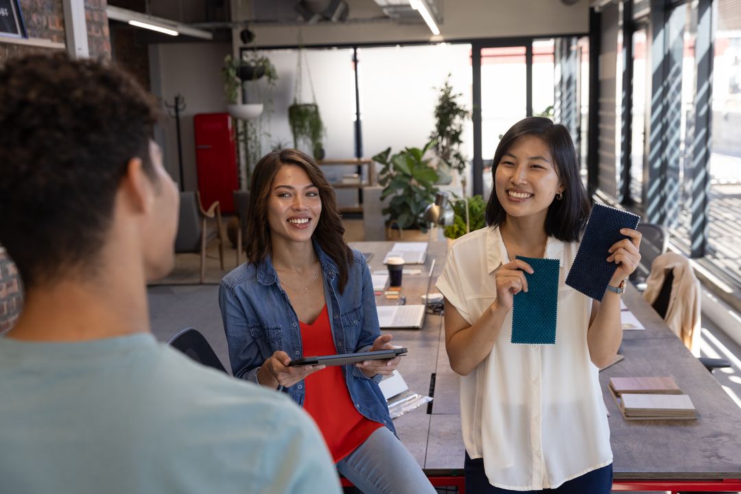 Diverse Coworkers Collaborating in Open-Plan Office with Color Samples