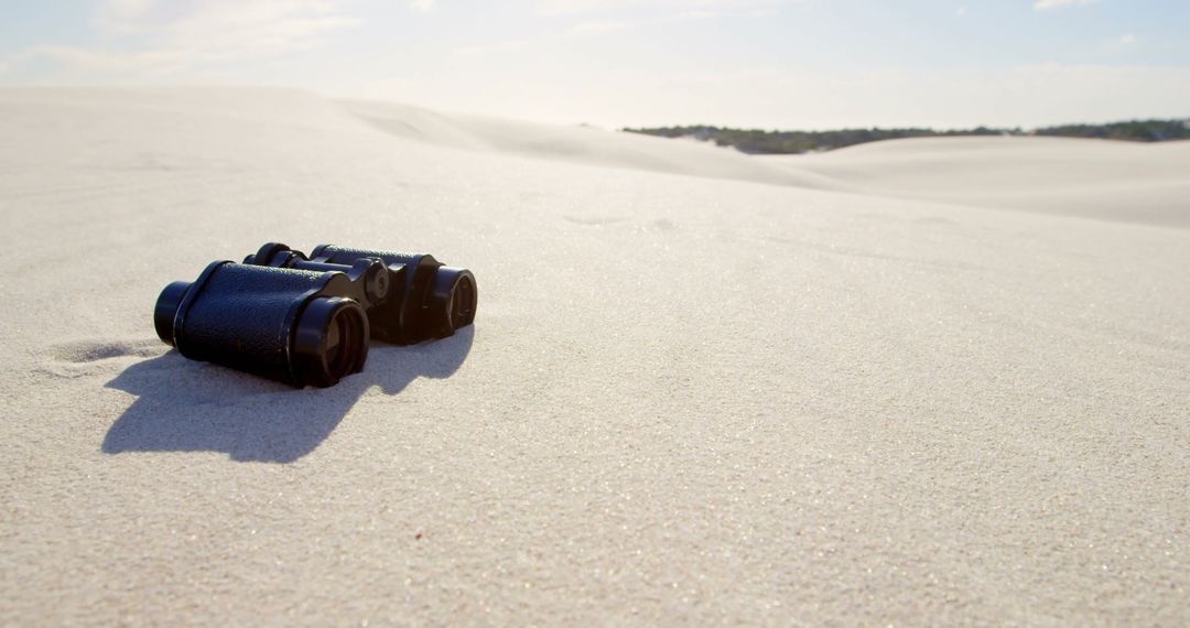 Binoculars Lying on Sandy Dunes in Desert Landscape - Free Images, Stock Photos and Pictures on Pikwizard.com