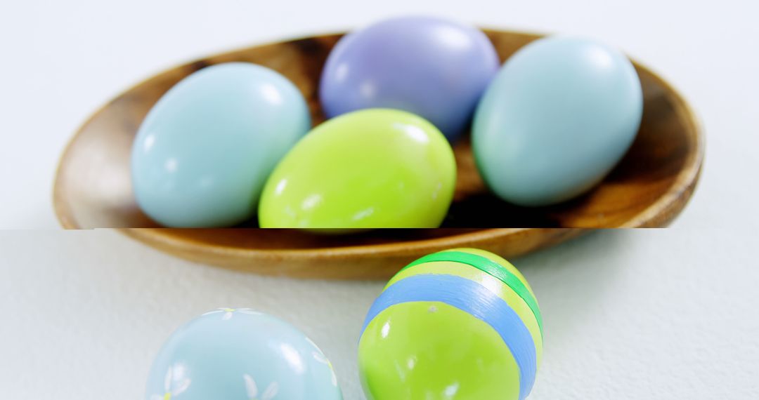 Colorful Easter eggs are arranged in a wooden bowl and on a white surface, with copy space - Free Images, Stock Photos and Pictures on Pikwizard.com