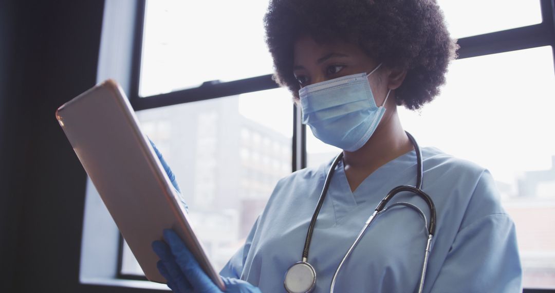 Healthcare worker reviewing tablet in hospital - Free Images, Stock Photos and Pictures on Pikwizard.com