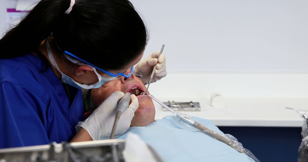 Dentist Performing a Dental Procedure on an Elderly Patient - Free Images, Stock Photos and Pictures on Pikwizard.com