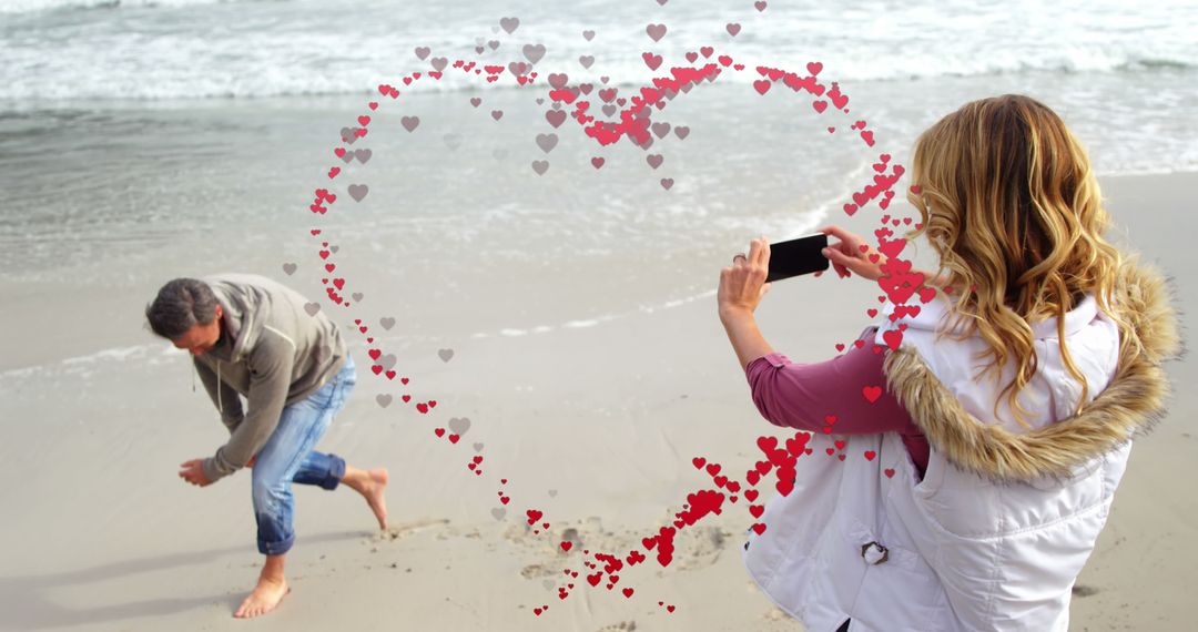 Couple Enjoying Beach Time with Romantic Heart Overlay - Free Images, Stock Photos and Pictures on Pikwizard.com