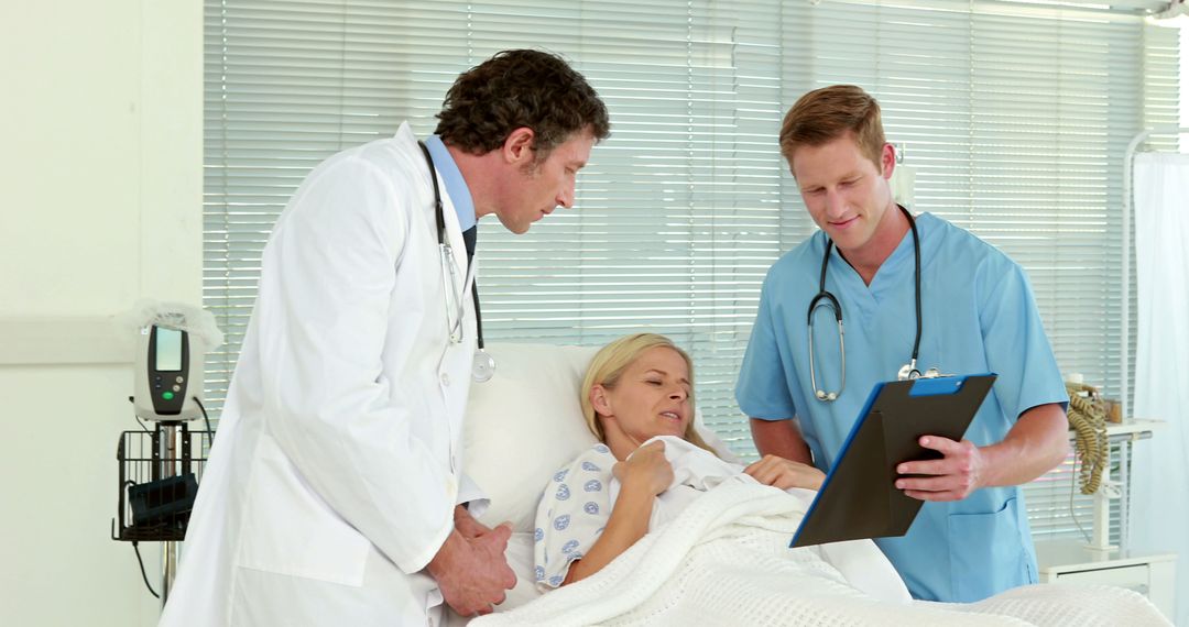 Doctors Discussing Patient Case with Woman in Hospital Bed - Free Images, Stock Photos and Pictures on Pikwizard.com