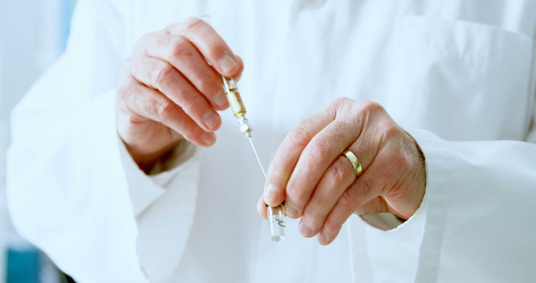 Close-Up of Doctor's Hands Managing Syringe and Medicine Vial in Lab Coat - Free Images, Stock Photos and Pictures on Pikwizard.com