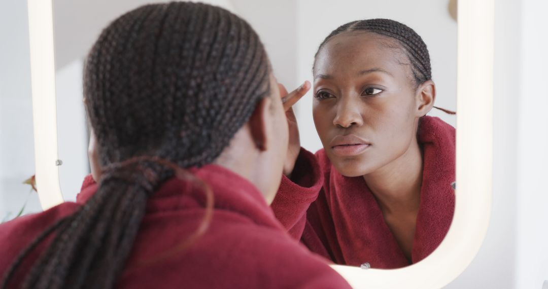 African American Woman Engaged in Morning Skincare Routine - Free Images, Stock Photos and Pictures on Pikwizard.com