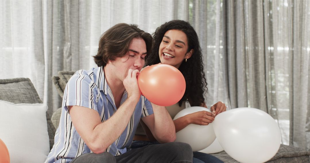 Couple Preparing for Birthday Party by Inflating Balloons at Home