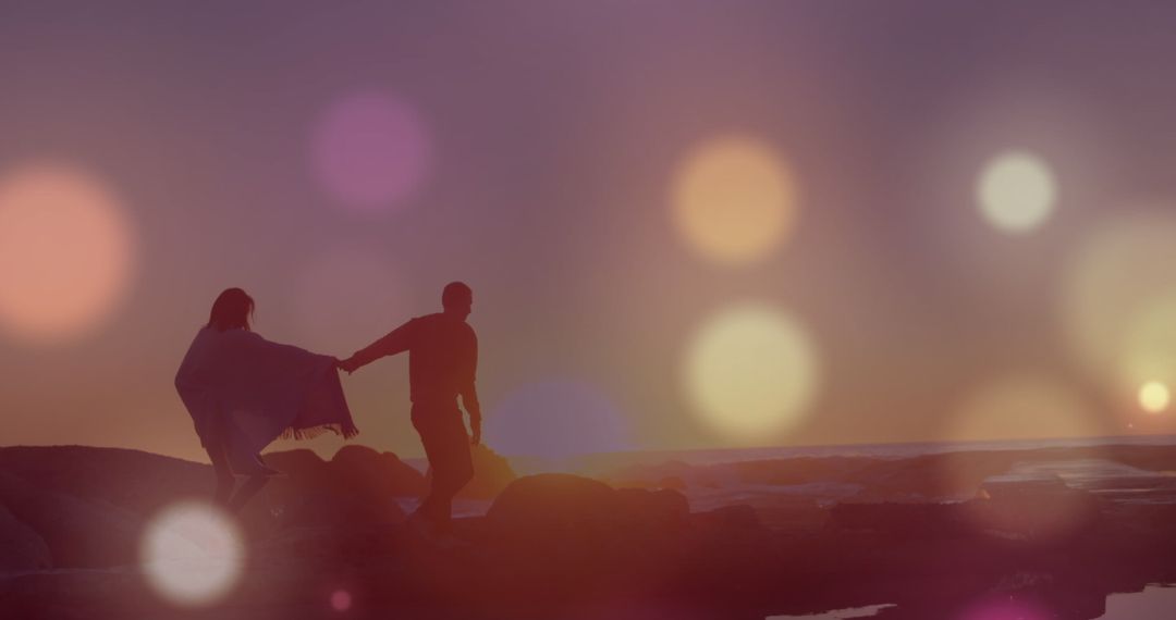 Couple Walking on Beach at Sunset with Bokeh Overlay
