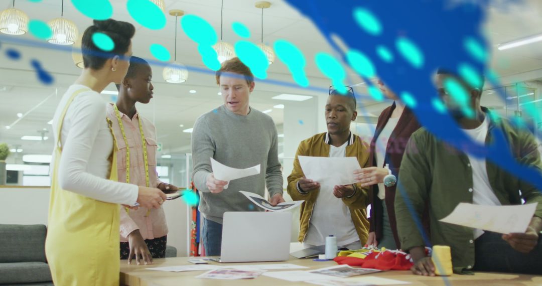 Diverse Team Collaborating Over Global Data Projection in Modern Office