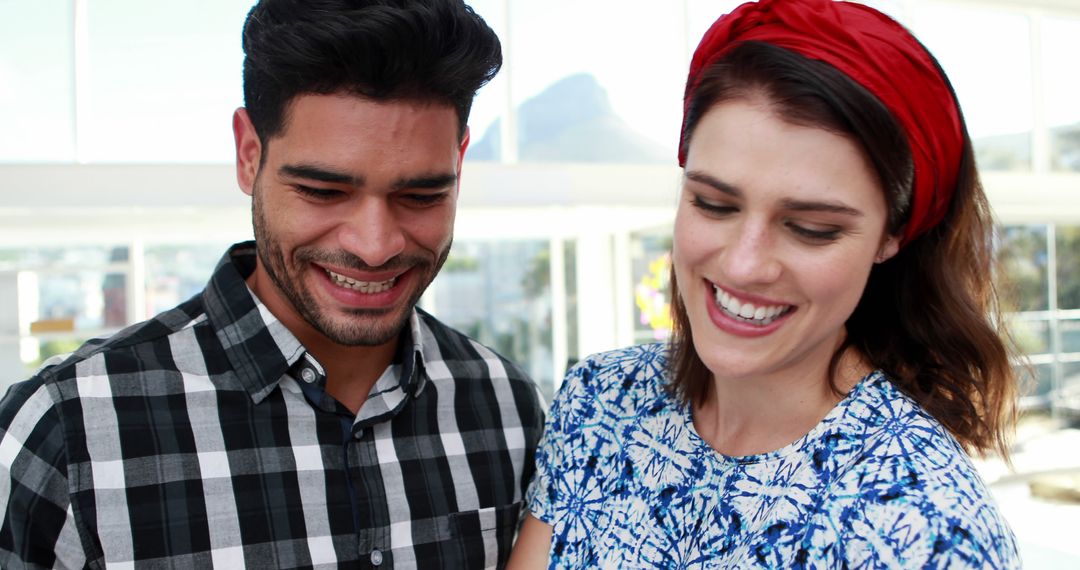 Joyful Young Couple Smiling in Bright Casual Atmosphere