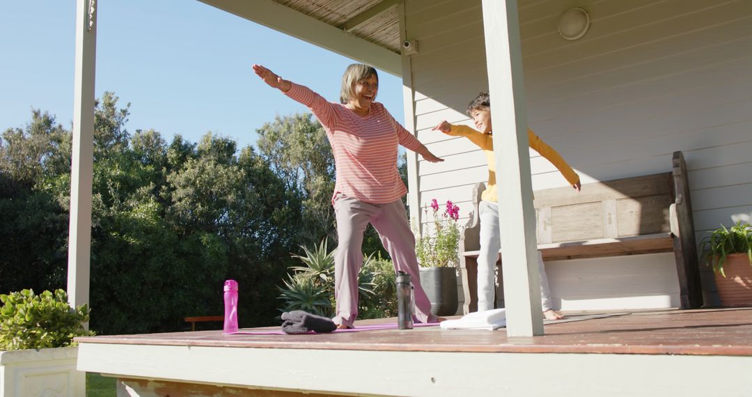 Elderly Woman and Girl Practicing Outdoor Yoga on Porch - Free Images, Stock Photos and Pictures on Pikwizard.com