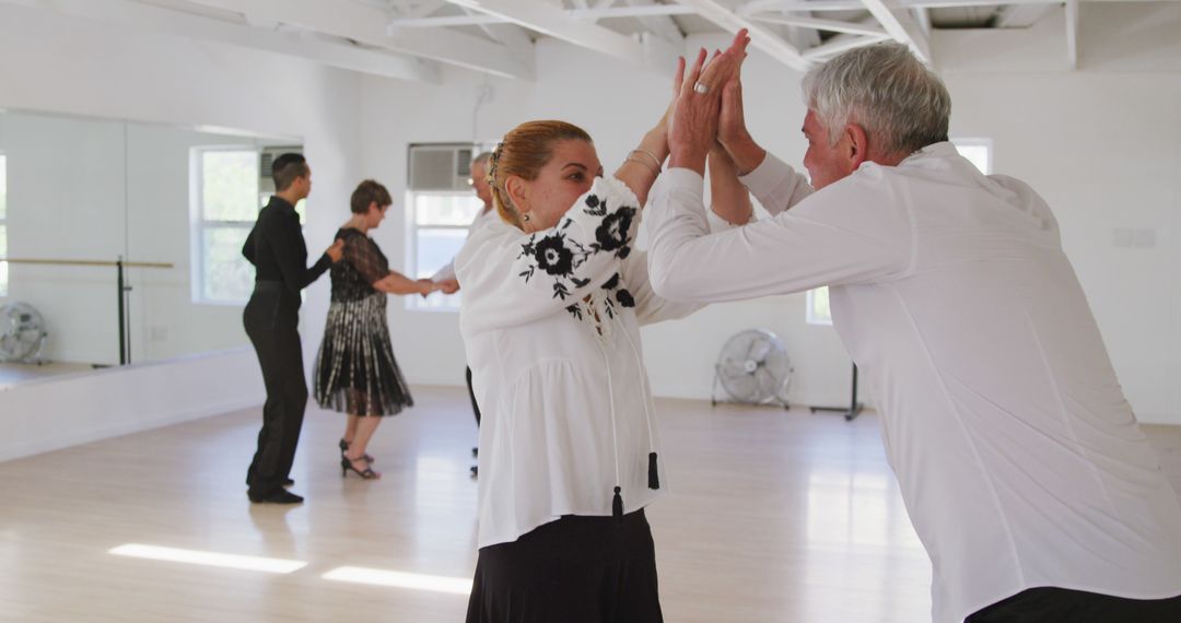 Senior Couples Learning Ballroom Dancing with Instructor