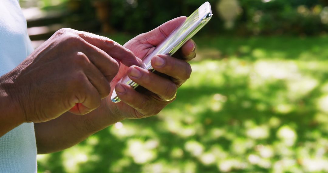 Close-up of Older Man Using Smartphone Outdoors in Sunny Day - Free Images, Stock Photos and Pictures on Pikwizard.com