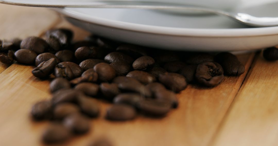 Close-Up of Coffee Beans with Saucers and Spoon on Wooden Surface - Free Images, Stock Photos and Pictures on Pikwizard.com